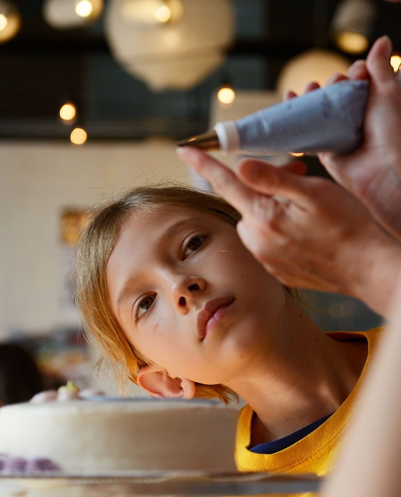 Charly Crouch, 11, studies a piping demonstration